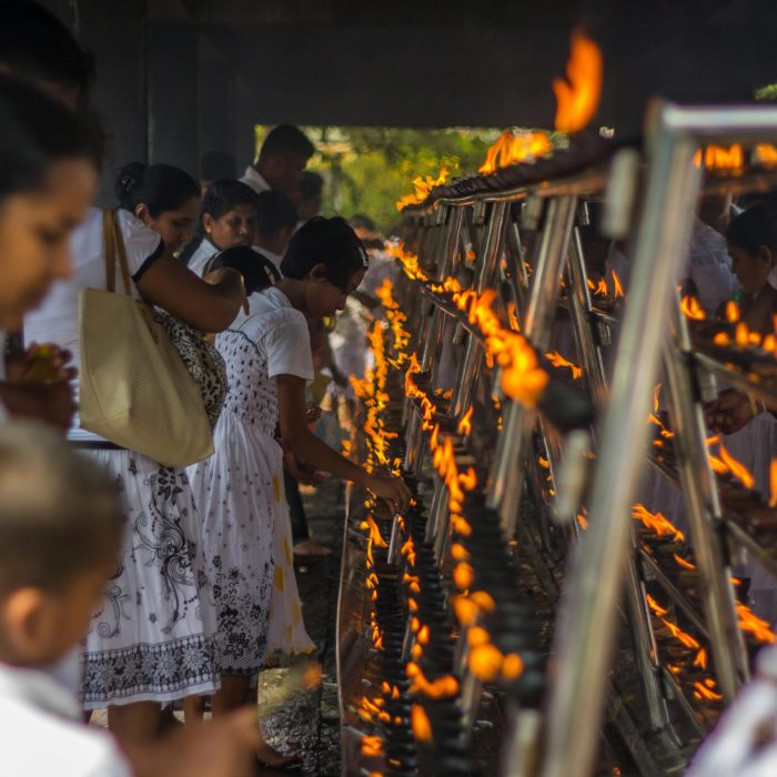 People gathering for a spiritual ritual with lighted candles in Anuradhapura, Sri Lanka.
